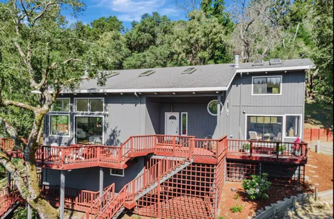 a backyard of a house with barbeque oven fire pit table and chairs