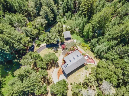an aerial view of a house with a yard and garden