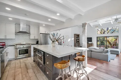 a large kitchen with kitchen island a large island in the center