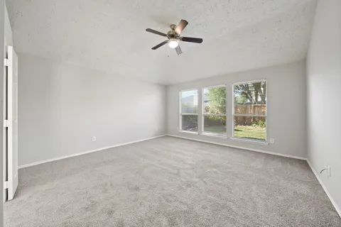 a living room with furniture and a kitchen