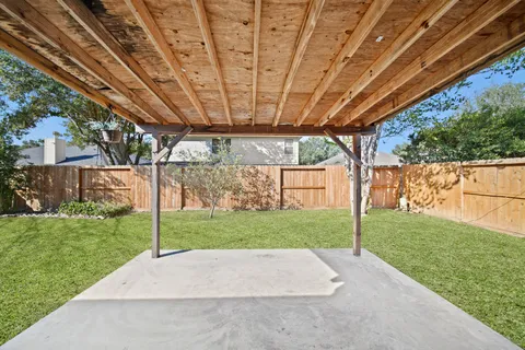 a view of a house with backyard and sitting area
