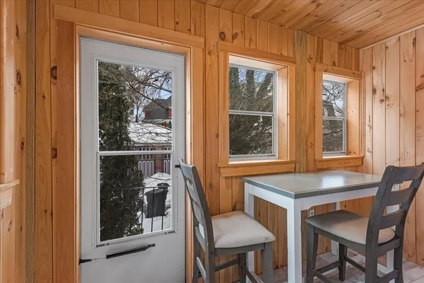 a view of a dining room with a table and chairs