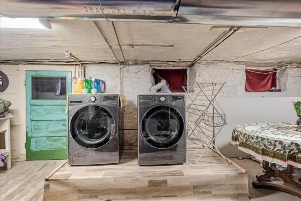 a view of a bedroom with washer and dryer