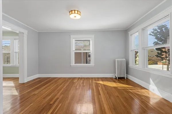 a view of a livingroom with wooden floor and a window