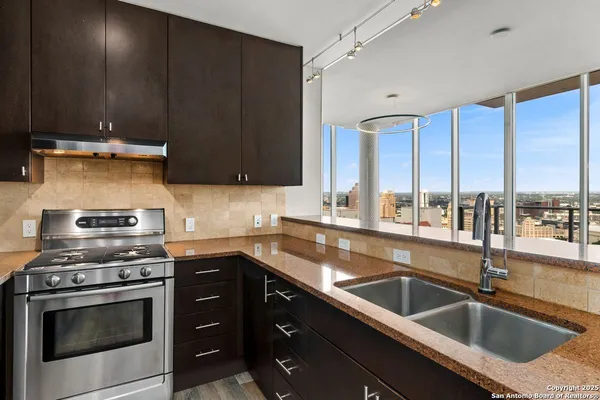 a kitchen with a sink stove and cabinets