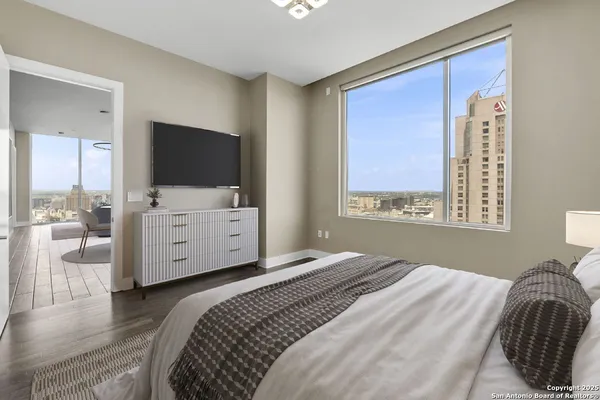a bedroom with a bed and a flat screen tv