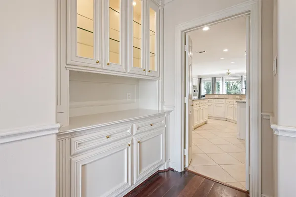 a view of a kitchen with wooden floor and cabinets