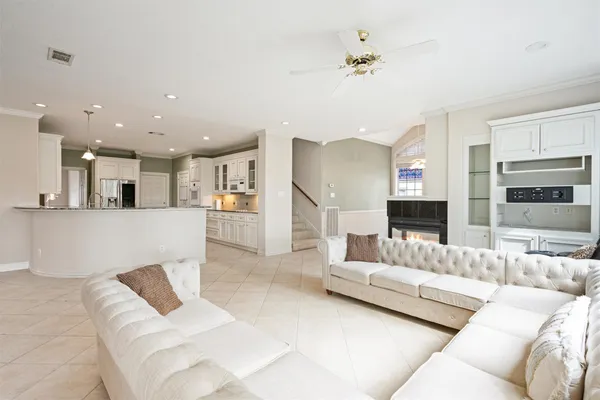 a living room with furniture and a view of kitchen