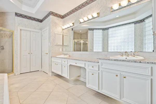 a spacious bathroom with a granite countertop sink mirror and a