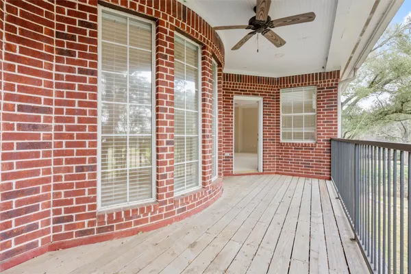 a view of a balcony with a floor to ceiling window and wooden floor