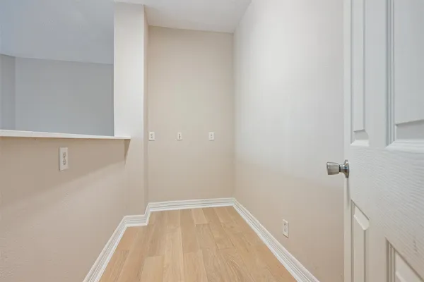a view of a room with wooden floor