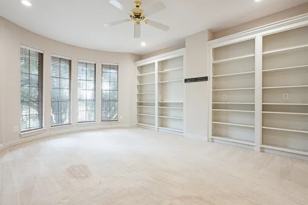 a view of an empty room with a window and a room