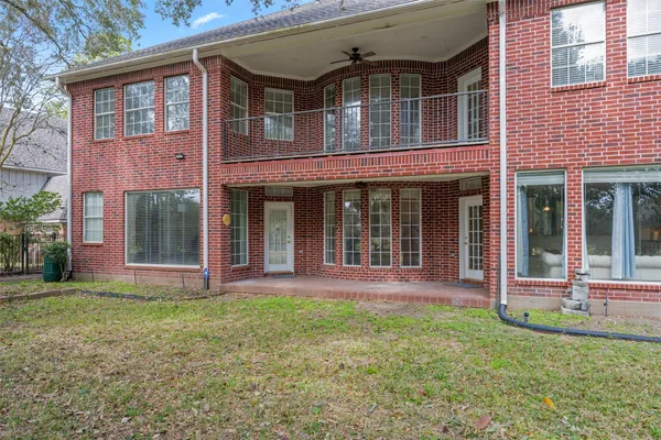front view of a brick house with a yard