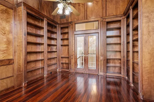 a view of a room with wooden floor and windows