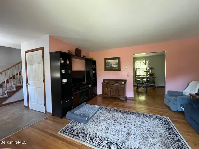 a dining room with furniture and wooden floor
