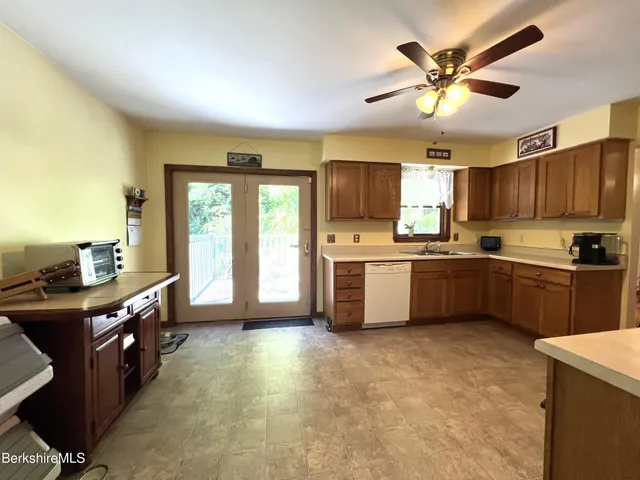 a kitchen with stainless steel appliances granite countertop a refrigerator a stove and a sink