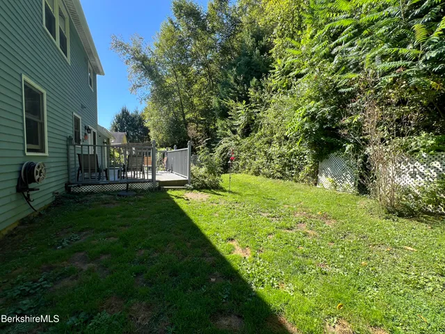 a view of table and chairs in patio of a house