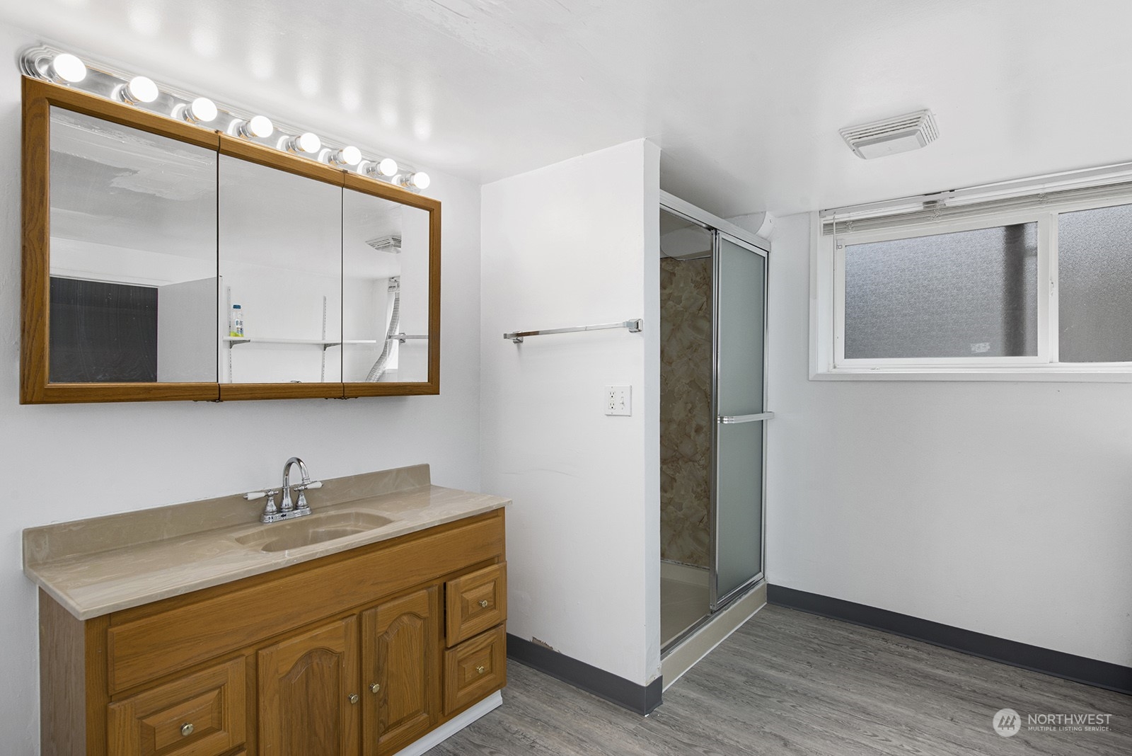 260 Taylor Avenue Northwest Renton, WA 98057 - Photo 19 of 26 a bathroom with a granite countertop sink mirror and cabinets