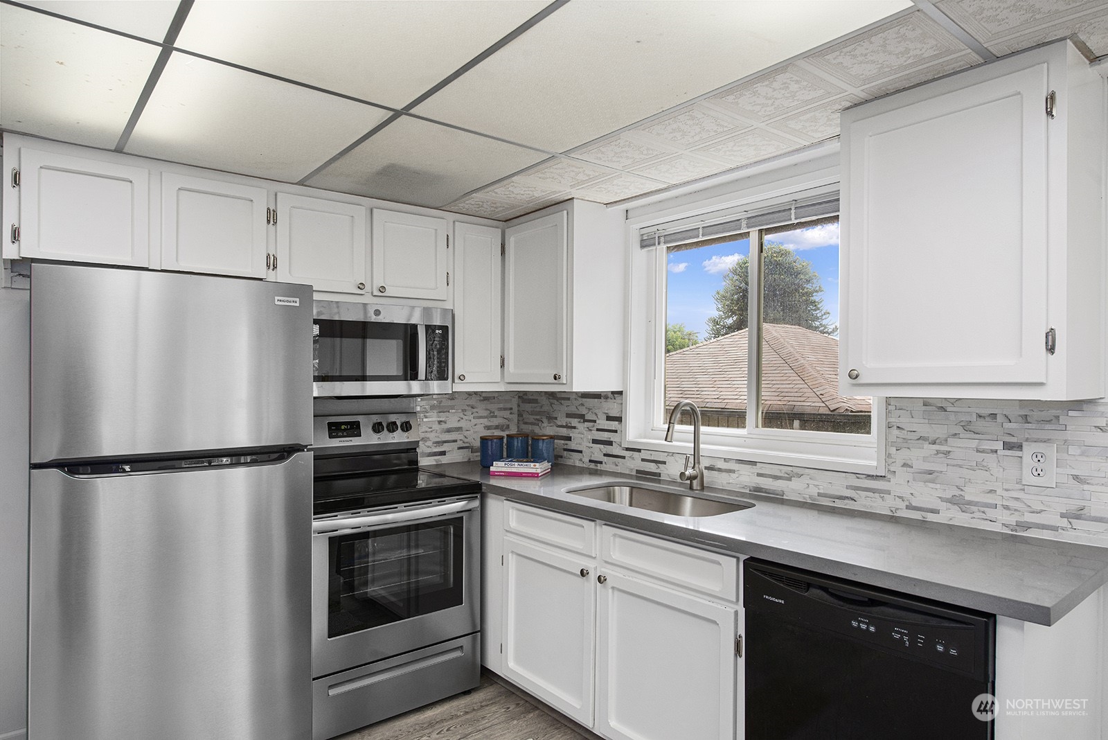 260 Taylor Avenue Northwest Renton, WA 98057 - Photo 3 of 26 a kitchen with a sink a refrigerator and cabinets