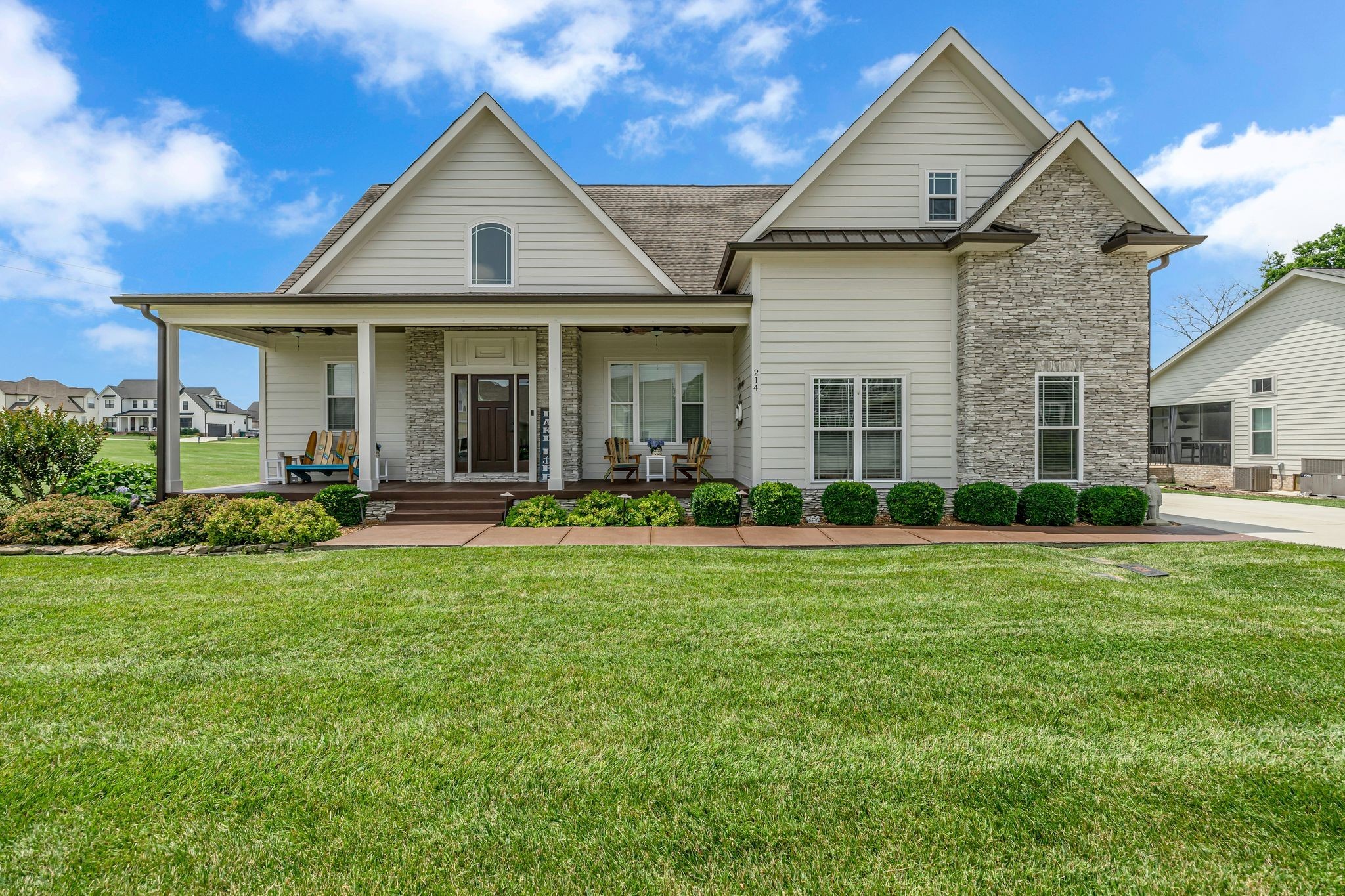 a front view of a house with a yard and porch