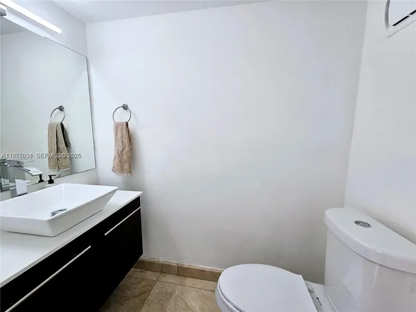 a large kitchen with a large counter top stainless steel appliances and cabinets