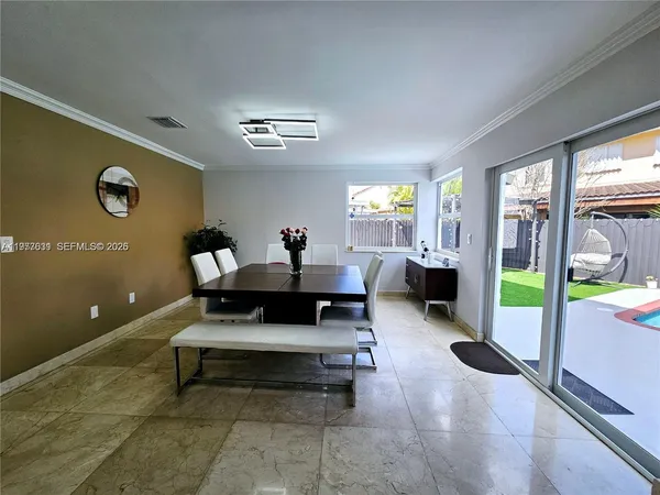 a view of a backyard with a patio and swimming pool