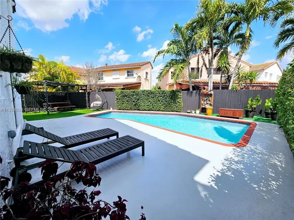 a patio with a yard table and chairs