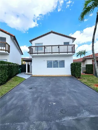 a view of a house with a yard and a garage