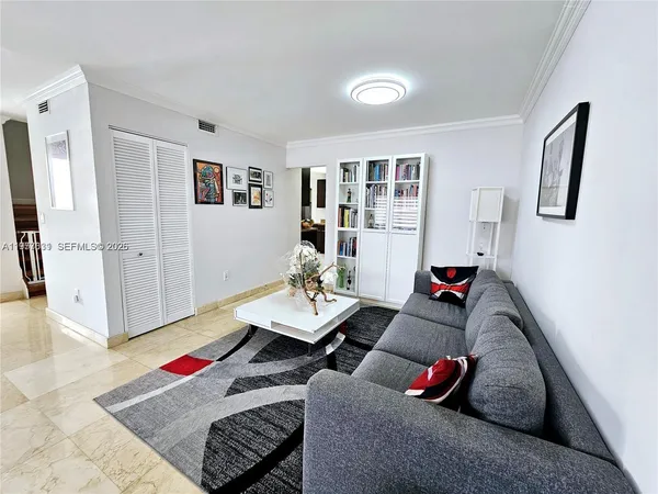a living room with furniture and a rug