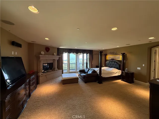 a living room with fireplace furniture and a flat screen tv