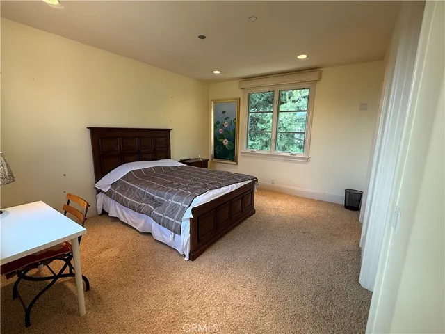 a bedroom with a bed and a table in it