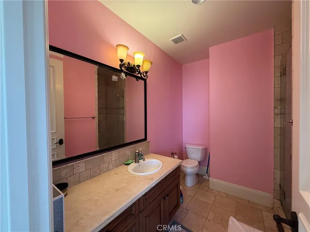 a bathroom with a sink vanity and a mirror