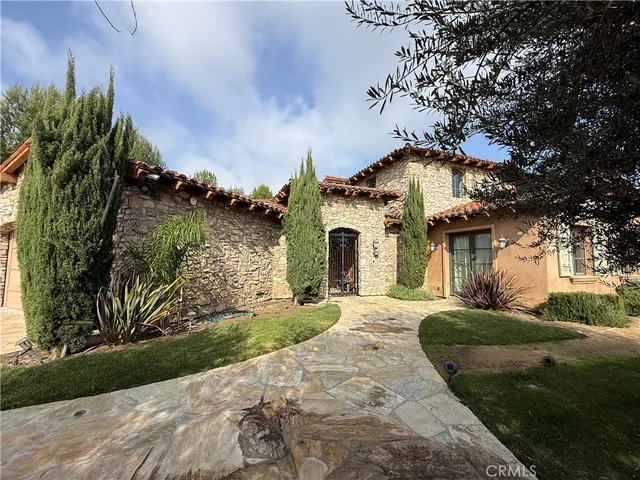 a view of a house with a yard and tree s