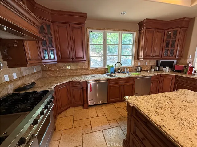 a kitchen with a sink stove and cabinets