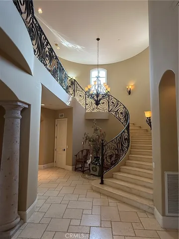 a very nice looking bedroom with a large bed and a chandelier