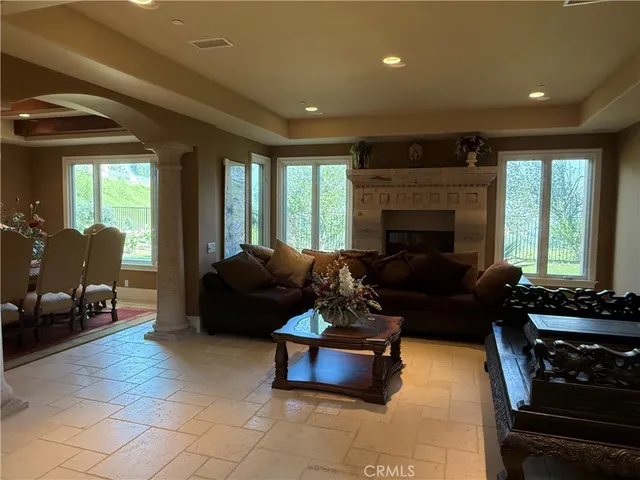a living room with furniture fireplace and window