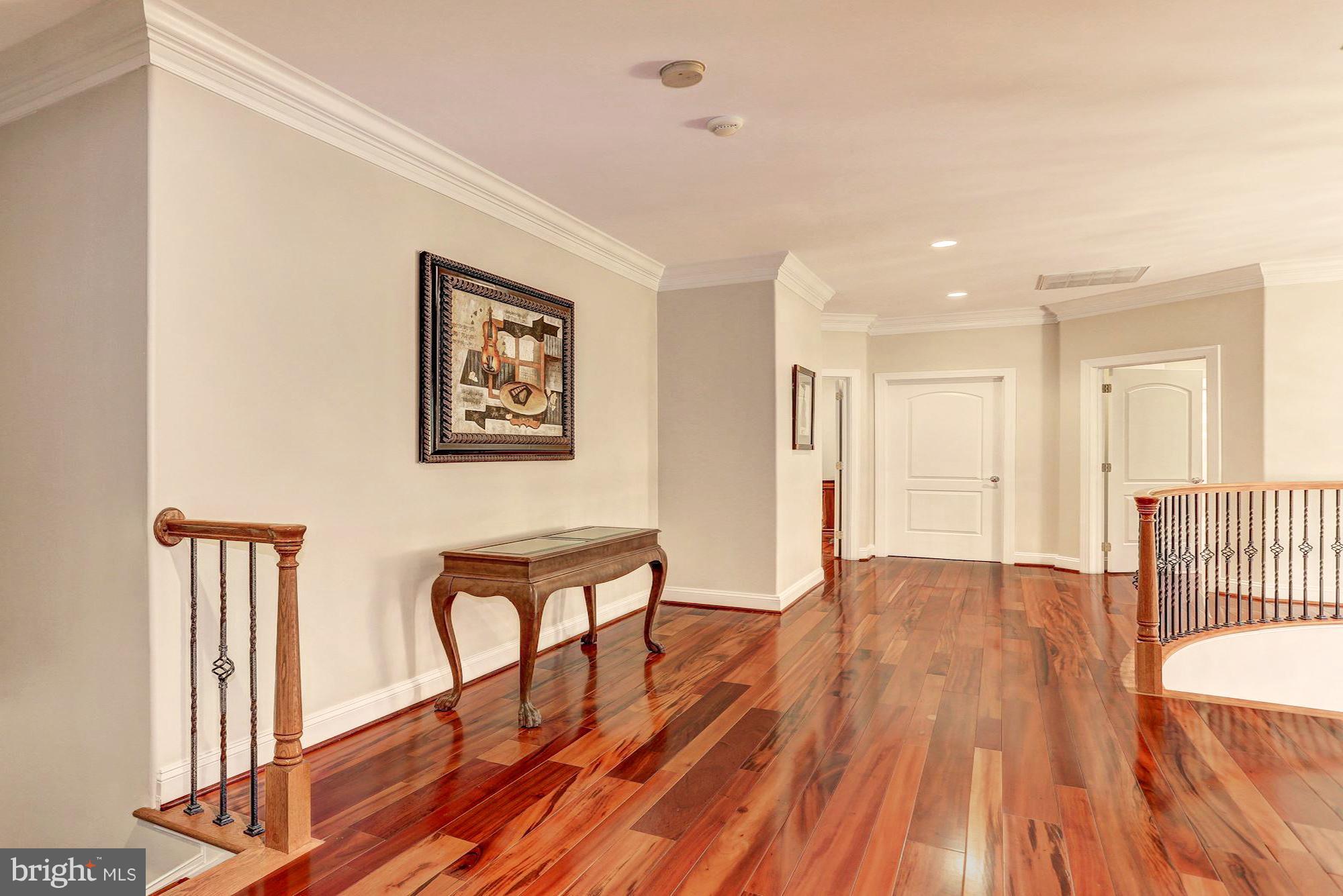 7111 Granberry Way Springfield, VA 22151 - Photo 15 of 30 a view of a hallway with wooden floor and furniture