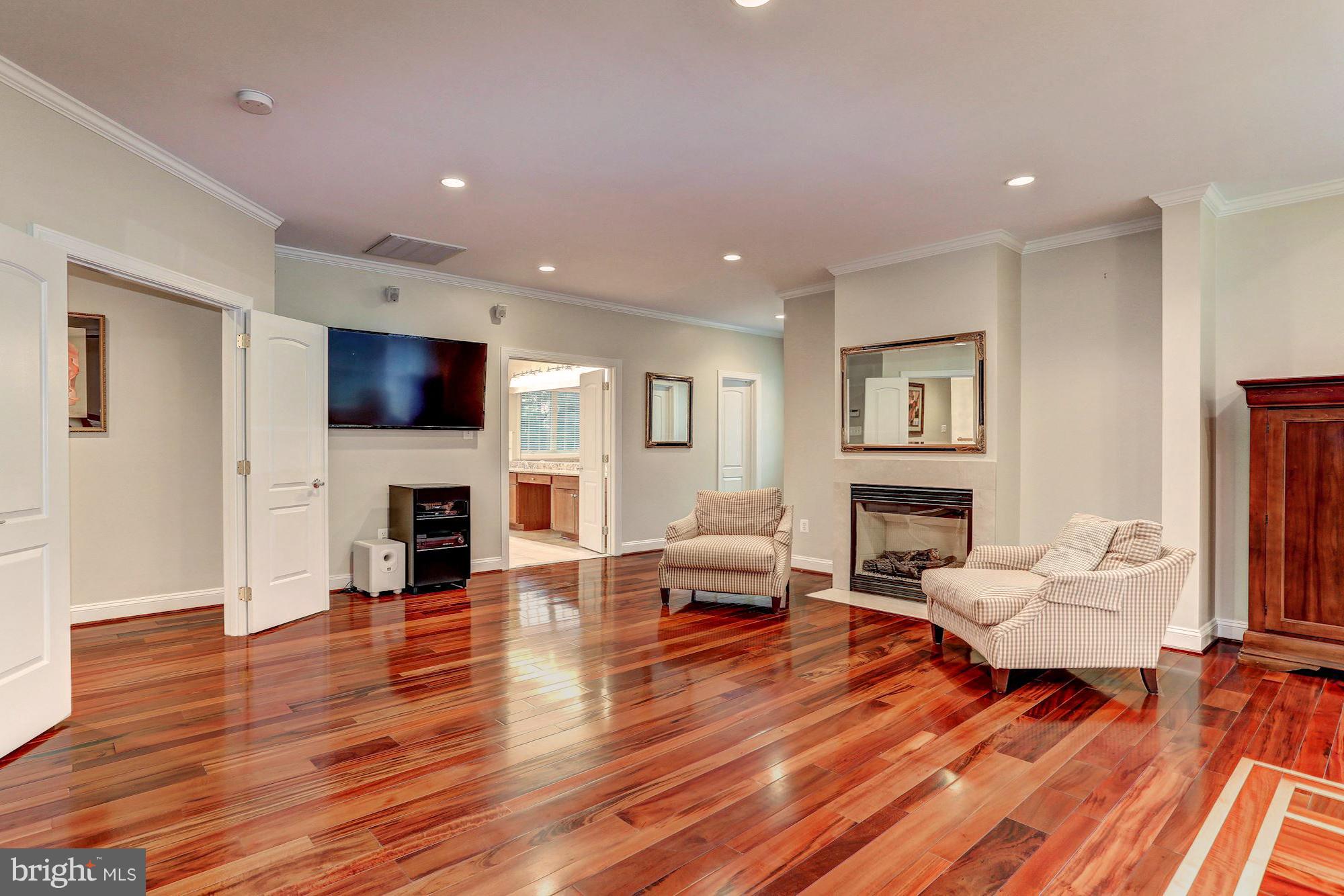 7111 Granberry Way Springfield, VA 22151 - Photo 17 of 30 a living room with fireplace furniture and a wooden floor