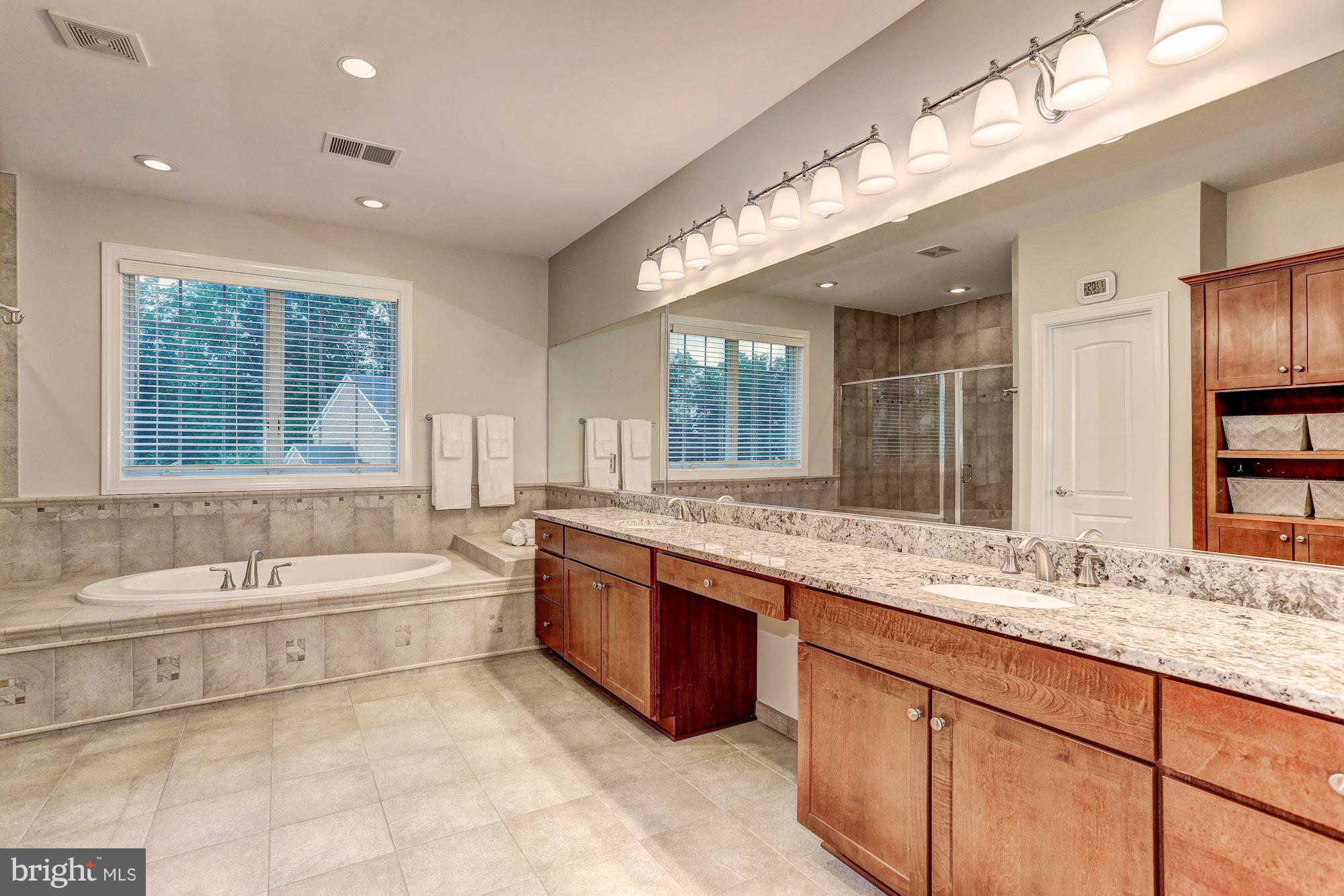 7111 Granberry Way Springfield, VA 22151 - Photo 18 of 30 a spacious bathroom with a large tub sink and double vanity