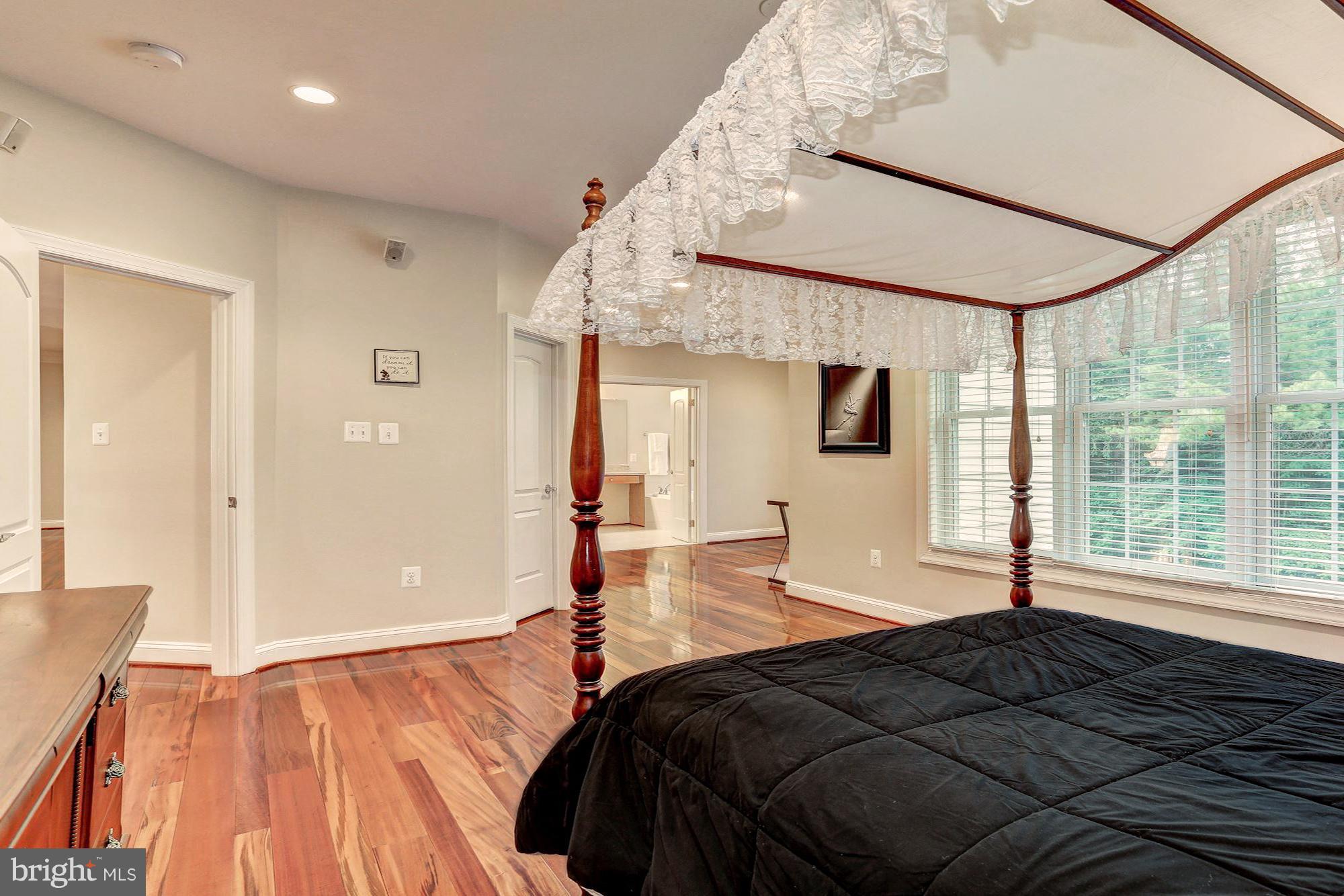 7111 Granberry Way Springfield, VA 22151 - Photo 20 of 30 a bedroom with a large bed and a large window