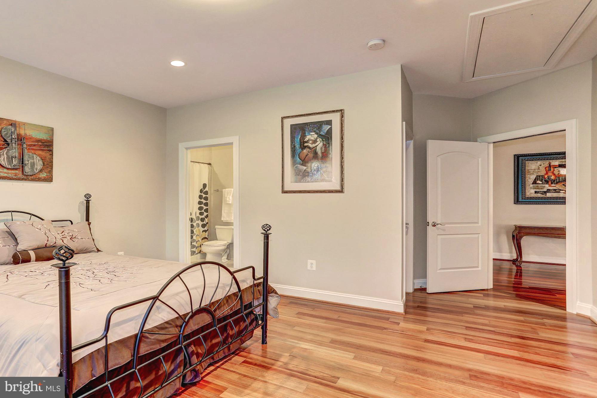 7111 Granberry Way Springfield, VA 22151 - Photo 21 of 30 a bedroom with a bed and wooden floor