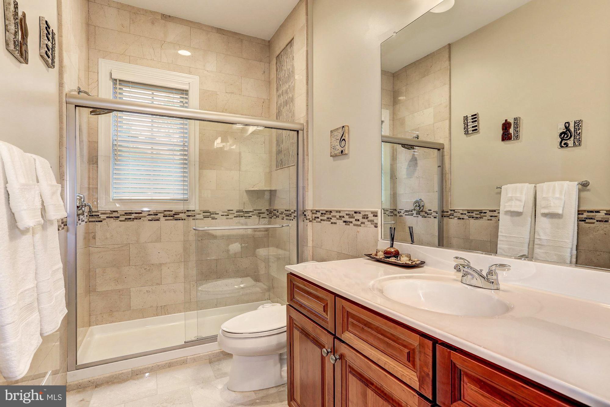 7111 Granberry Way Springfield, VA 22151 - Photo 27 of 30 a bathroom with a sink a toilet and shower