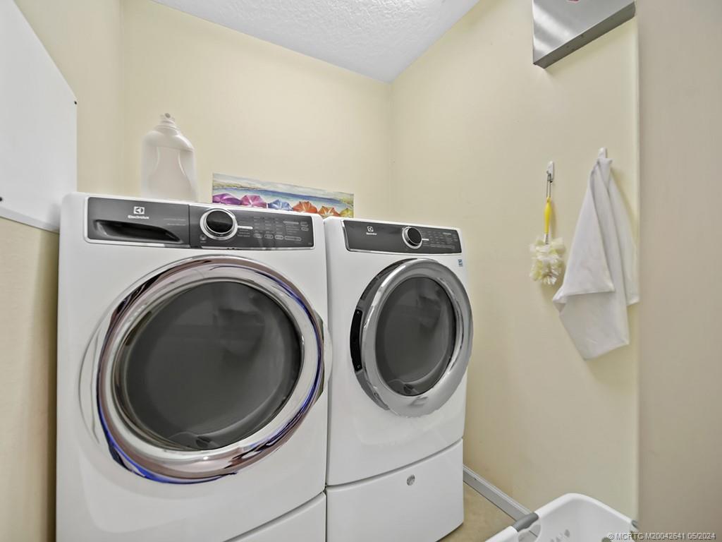 570 Northwest Red Pine Way Jensen Beach, FL 34957 - Photo 13 of 19 a utility room with dryer and washer