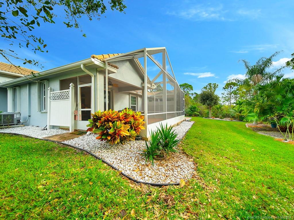 570 Northwest Red Pine Way Jensen Beach, FL 34957 - Photo 2 of 19 a view of a house with backyard and porch
