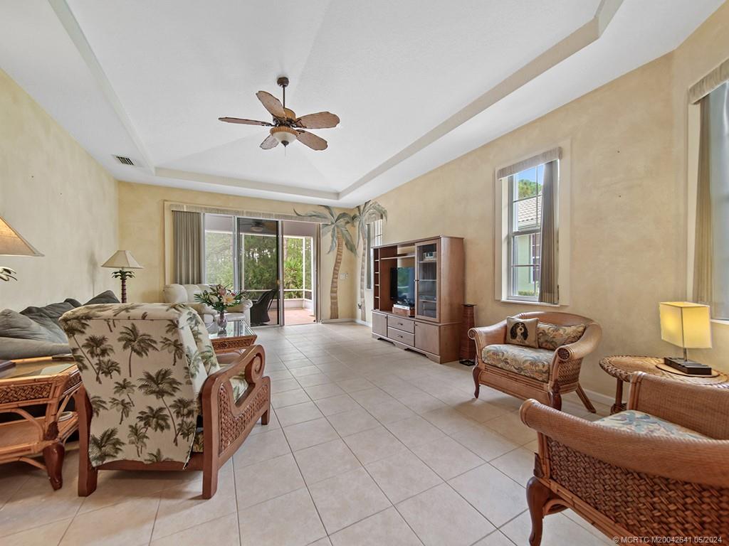 570 Northwest Red Pine Way Jensen Beach, FL 34957 - Photo 7 of 19 a bedroom with furniture and a large window