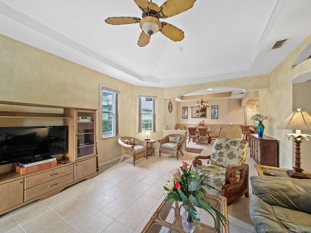 570 Northwest Red Pine Way Jensen Beach, FL 34957 - Photo 9 of 19 a living room with furniture and a flat screen tv