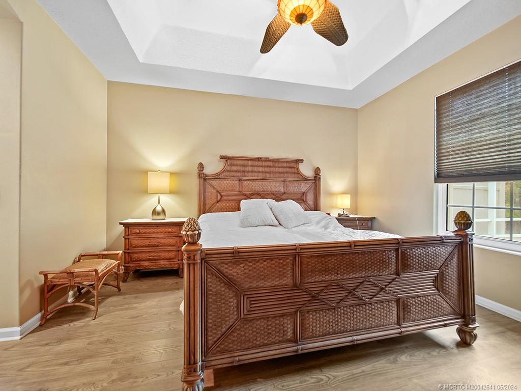 570 Northwest Red Pine Way Jensen Beach, FL 34957 - Photo 10 of 19 a bedroom with a bed and window