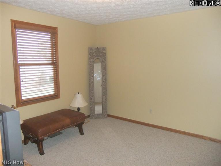 3795 Stonebridge Boulevard Akron, OH 44321 - Photo 14 of 24 The first bedroom features neutral carpet...