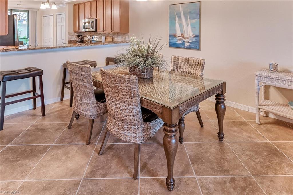 9528 Avellino Way, Unit 2515 Naples, FL 34113 - Photo 7 of 35 a view of a dining room with furniture and a potted plant