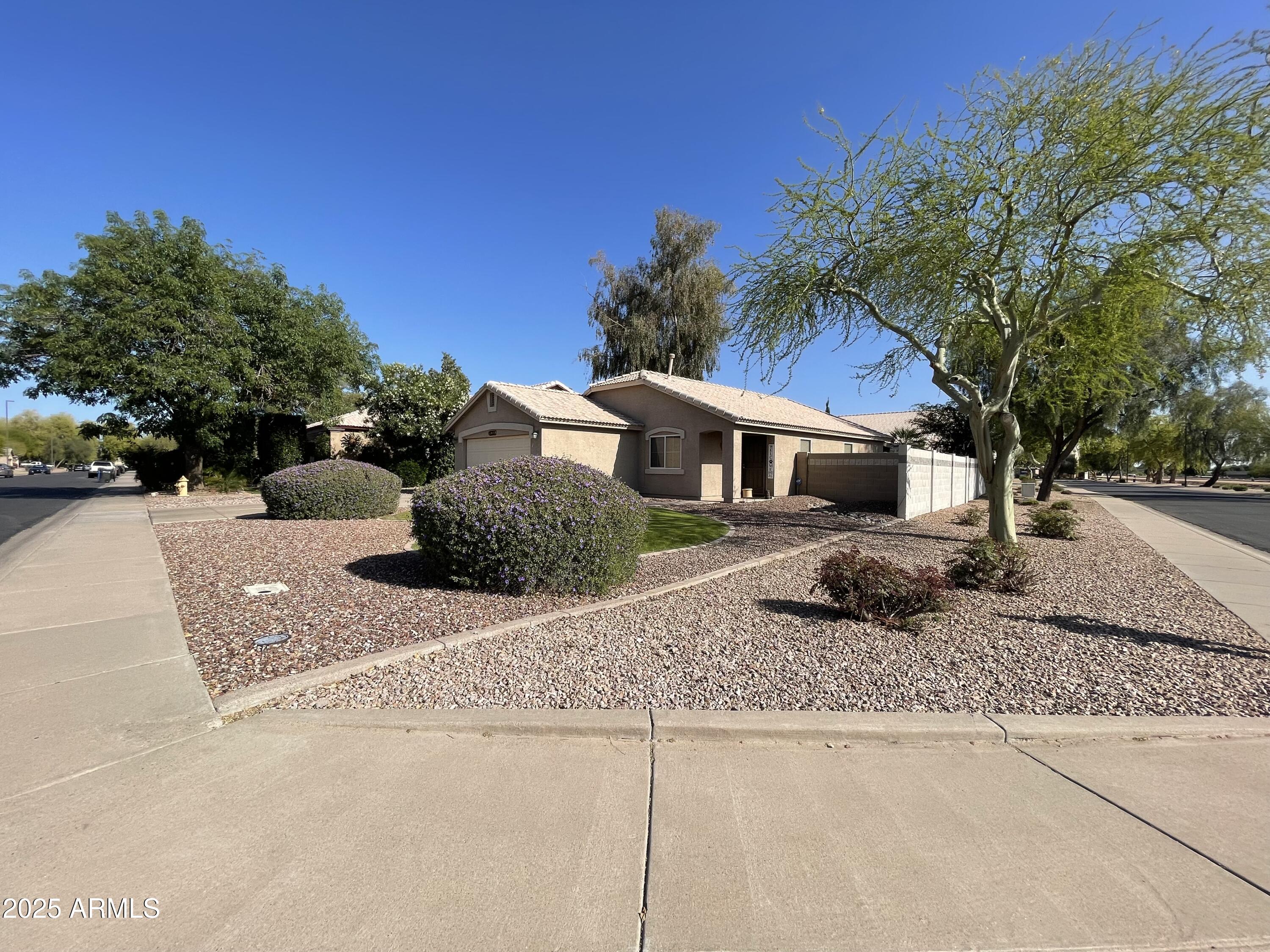 2735 East Harwell Road Gilbert, AZ 85234 - Photo 2 of 43 a front view of a house with a yard and garage